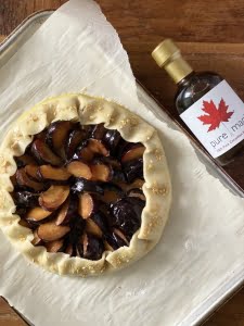 Maple plum pie on baking tray