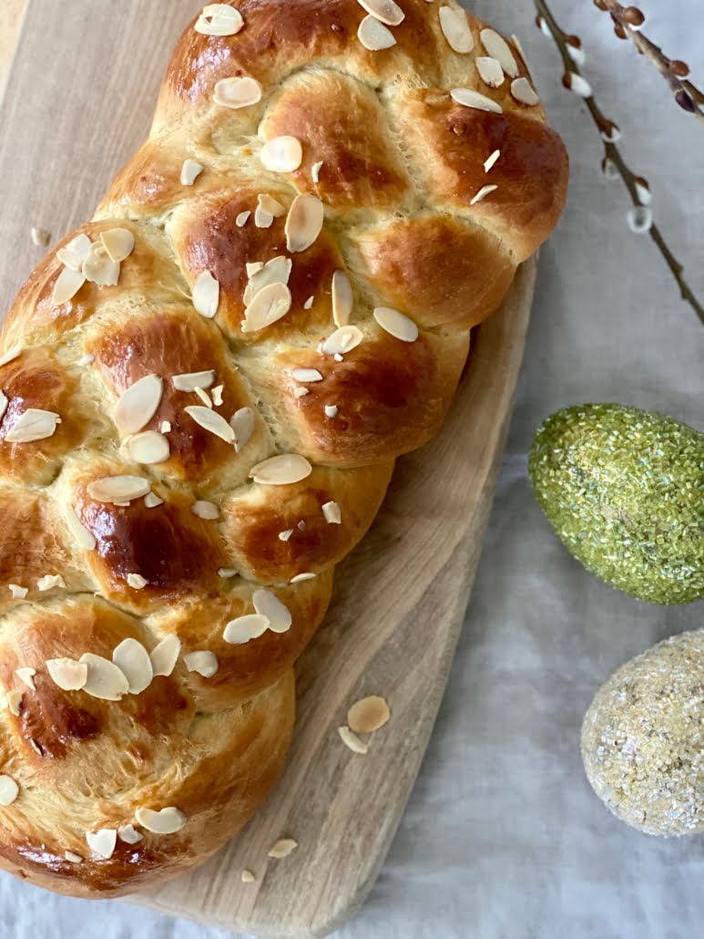 Easter bread decorated with almond flakes and 2 large decorated eggs to the side - Pure Maple