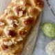 Easter bread decorated with almond flakes and 2 large decorated eggs to the side - Pure Maple