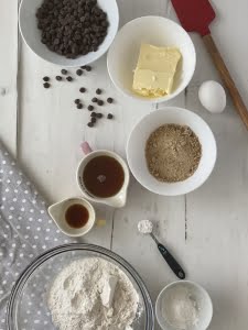 Chocolate chip cookie ingredients spread out on table