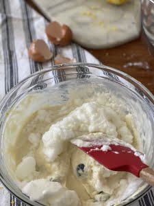 Lemon and blueberry pancake batter, folding in the egg whites into the batter