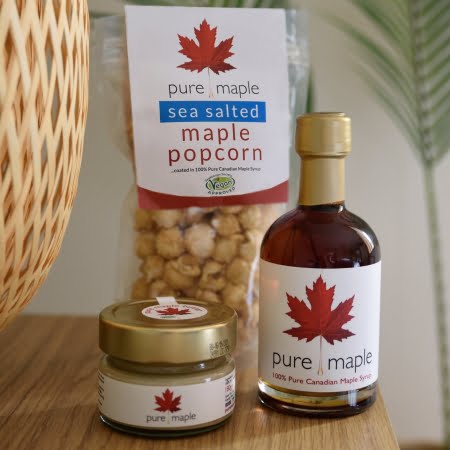 Bottle of Amber Rich Maple Syrup, bag of Popcorn, jar of Maple Butter
