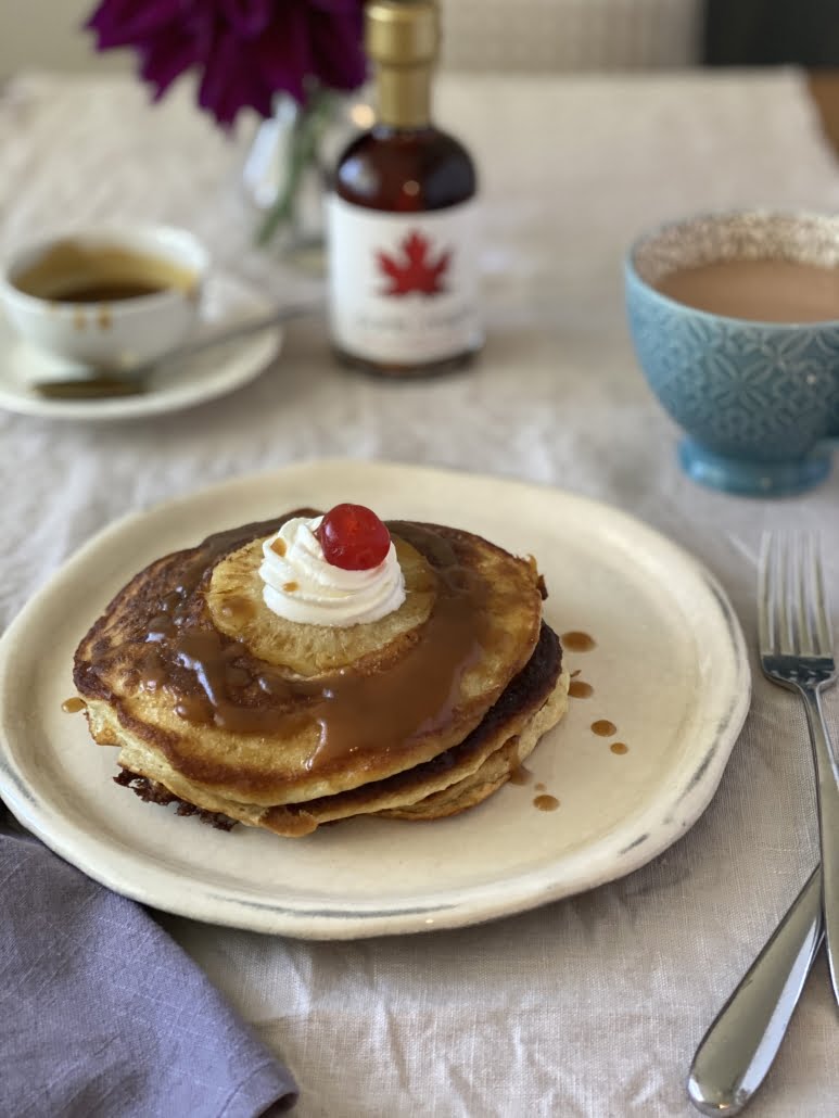 Upside down pineapple pancakes with maple caramel sauce, whipping cream and a cherry on top - Pure Maple Syrup