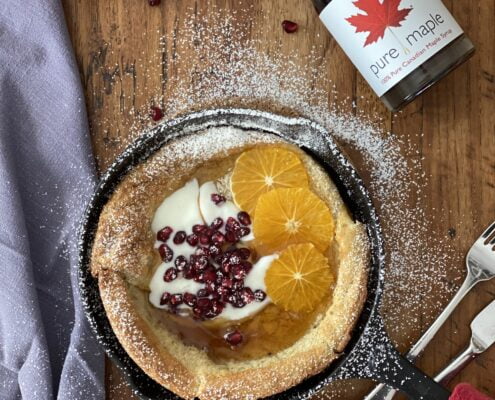 Christmas Dutch Baby Pancakes with yogurt pomegranate orange slices and maple syrup - Pure Maple