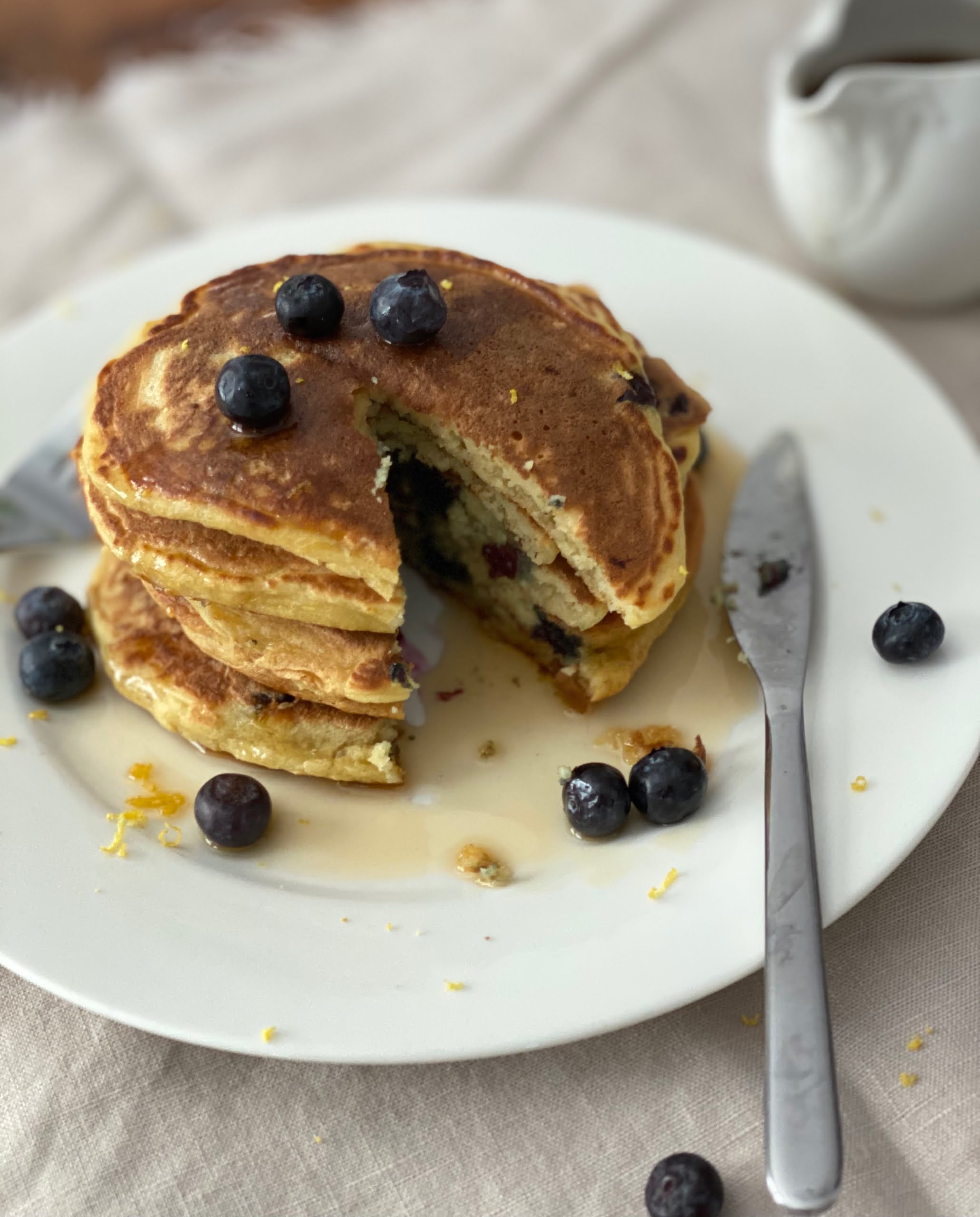 Lemon and Blueberry Ricotta Pancakes with a section cut out - Pure Maple