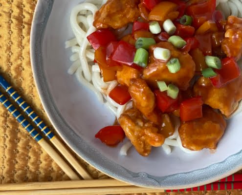 Sweet and Sour Chicken with noodles and spring onion garnish- Pure Maple