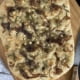 Maple Onion and Feta Focaccia on a cutting board with a knife to the side - Pure Maple